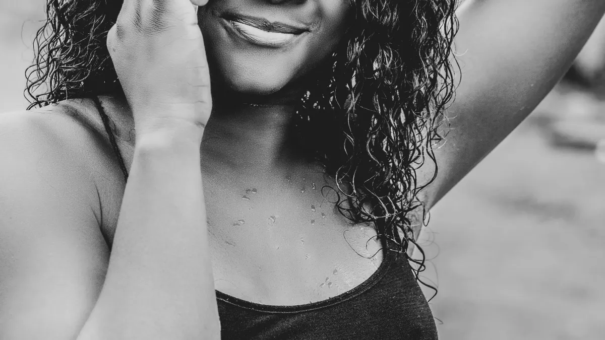 Smiling woman answering a call on her smartphone